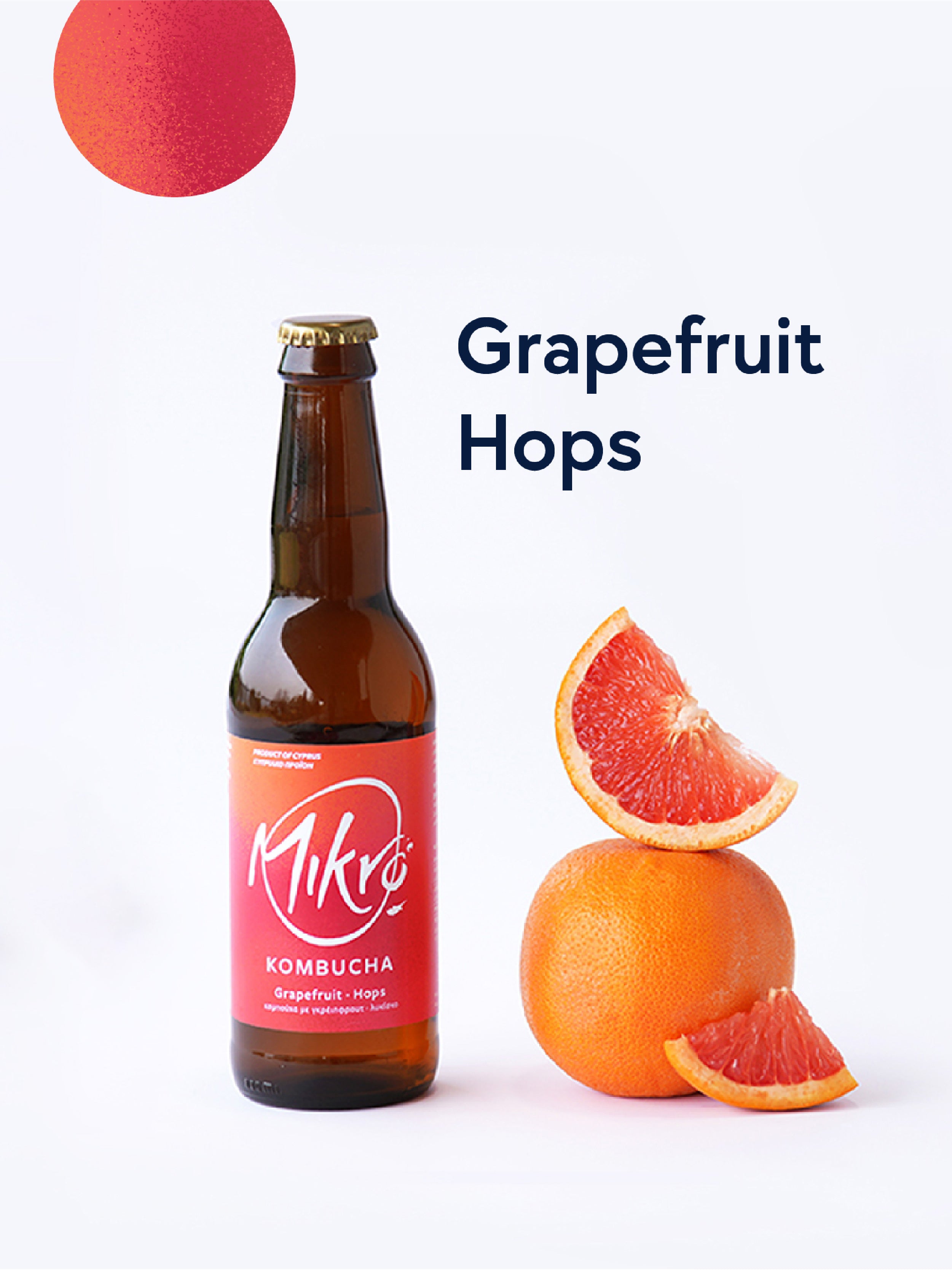 Mikro Grapefruit Hops Kombucha bottle with red and orange label next to grapefruit wedges on a white background
